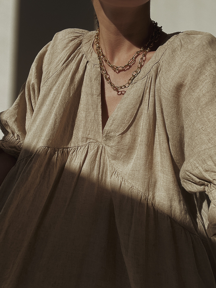 Vintage Beige Shiny Dress Worn by a Woman